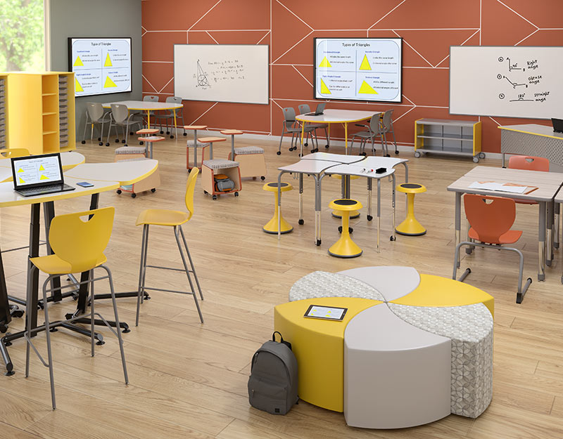 Bright science room with high top tables and soft seating.