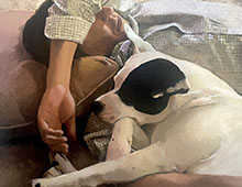 Painting of a person and dog sleeping together.