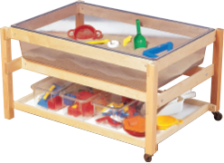 Table with bin of sand and sand toys and a shelf for storage below.