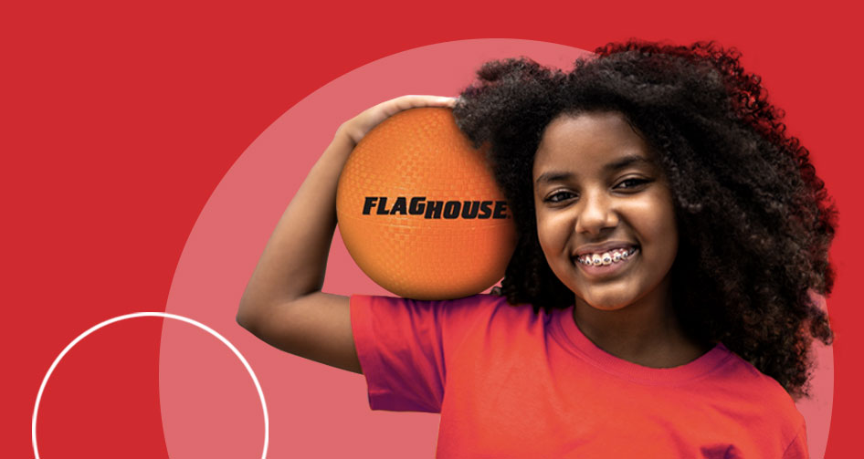 teenaged girl holding an orange flaghouse playground ball