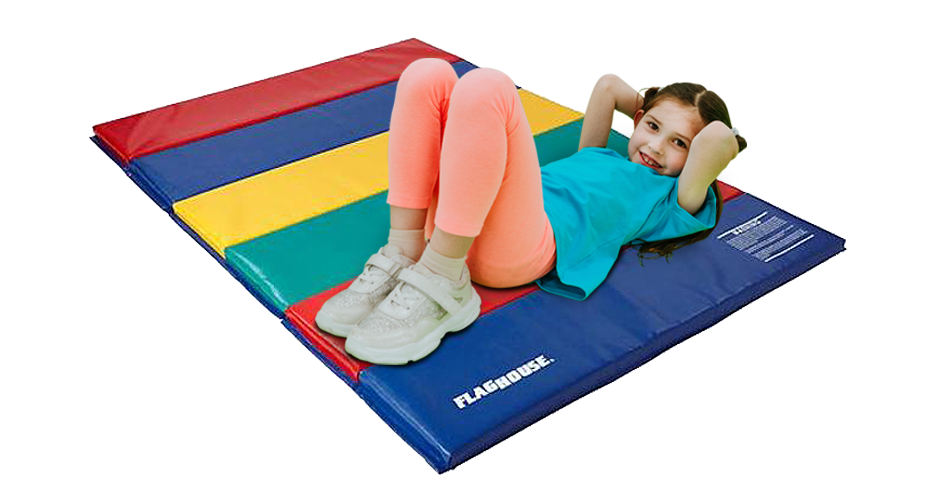little girl laying on flaghouse multi colored mat